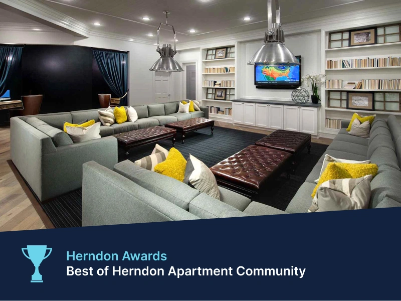 Herndon Award with resident lounge at Halstead Dulles featuring sectional sofas, bookshelves, and media center