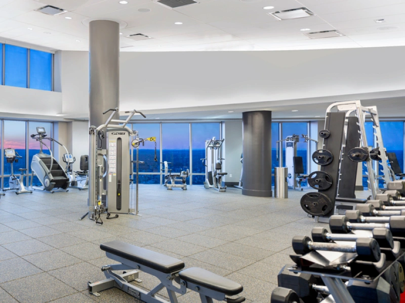 Spacious apartment fitness center with panoramic windows and strength training equipment in Halstead New Rochelle