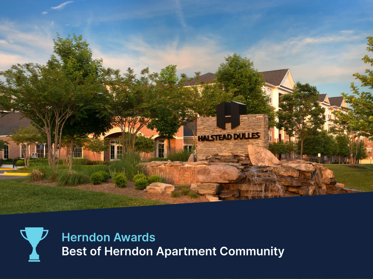 Award-winning Halstead Herndon Dulles apartment complex exterior with mature trees and upscale community signage