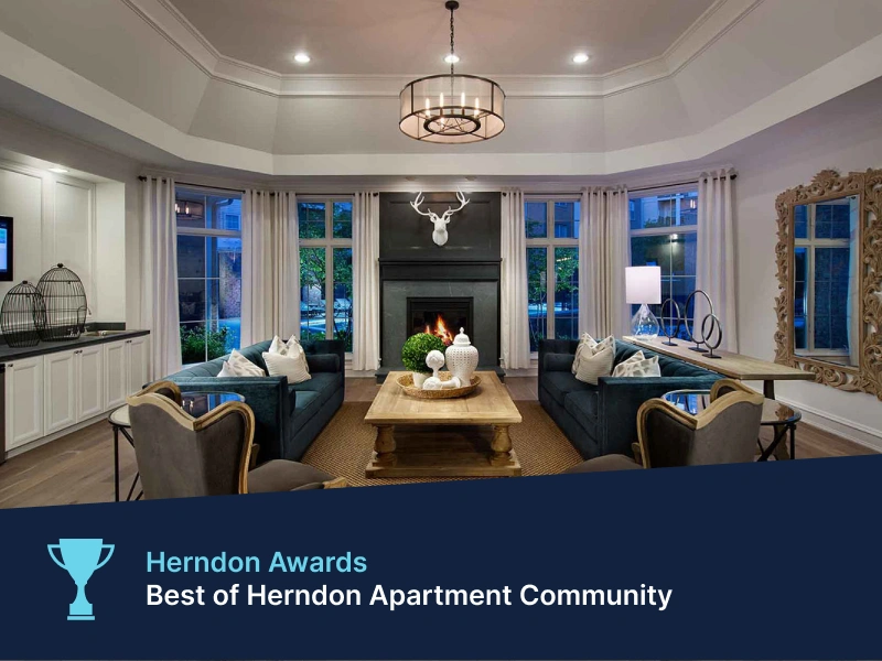 Upscale resident clubhouse with fireplace and velvet seating in Herndon Awards community recognition graphic