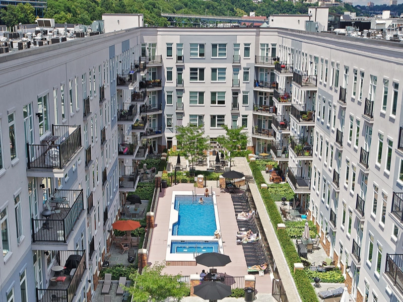 Aerial view of Halstead 800 Madison apartment courtyard with central pool and green landscaping
