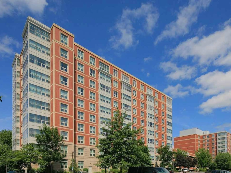 Urban residential tower acquired by DSF Group in Burlington, MA featuring glass and brick architecture