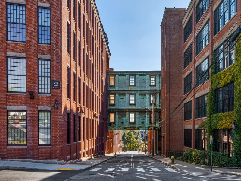 Industrial-style buildings with red brick and large windows connected by vintage skybridge in Providence,RI