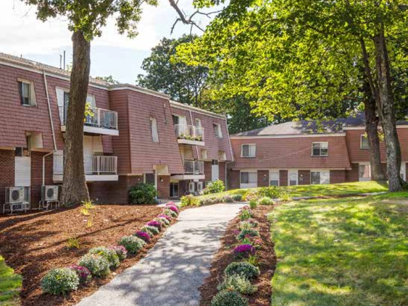 DSF Group 304-Unit Multifamily property in Milford featuring red siding and balconies