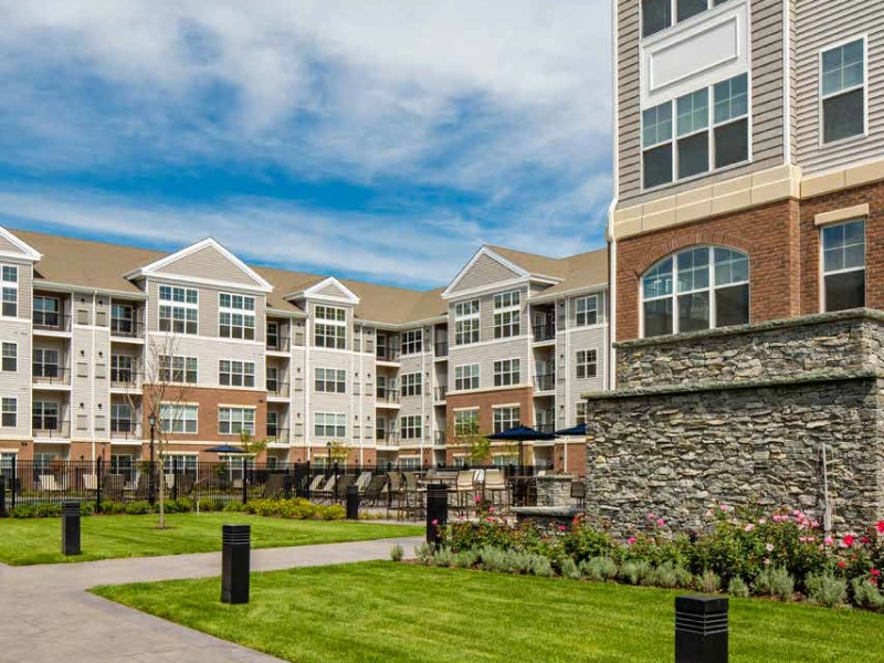 DSF Group property in Norwalk featuring brick and siding apartments with elegant stone accents