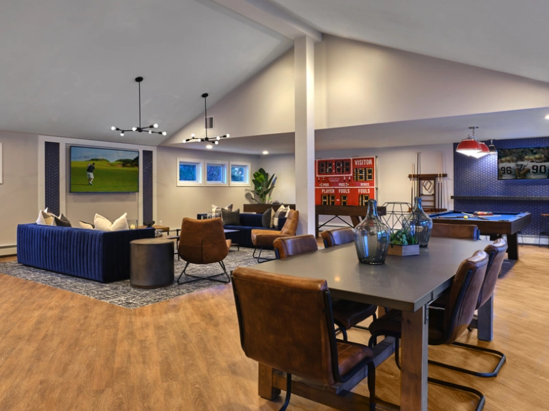 Stylish apartment clubhouse lounge with cozy seating, modern lighting, and entertainment amenities in Manchester NH
