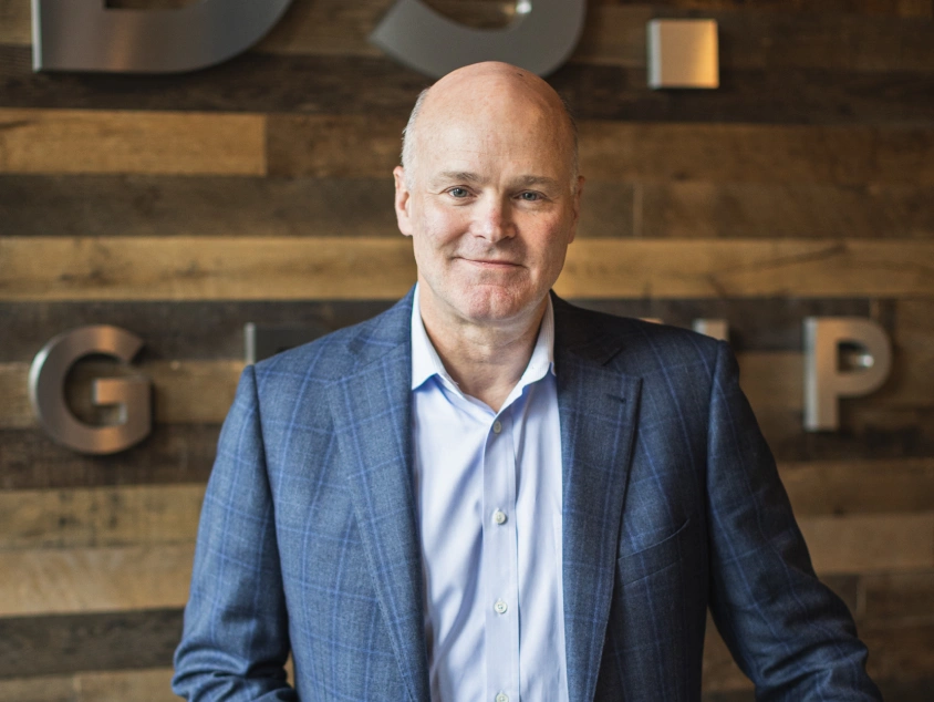 Business leader Josh Solomon standing proudly in office with DSF branding behind him