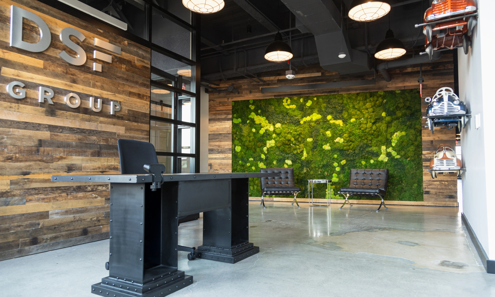 Open entry space combining contemporary decor, natural textures, and quirky automobile wall accents