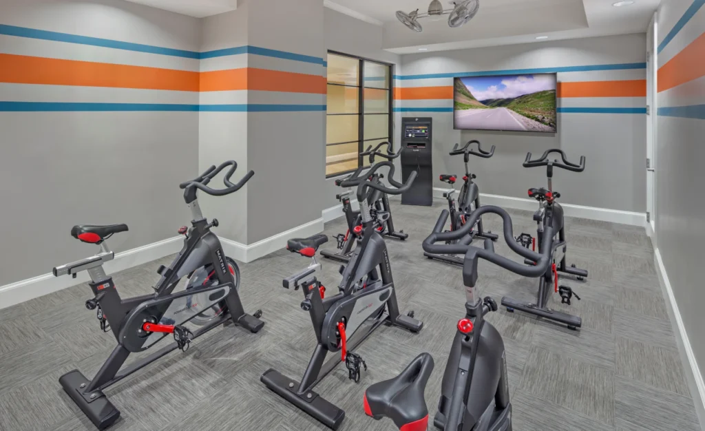 Indoor cycling studio with stationary bikes, flat-screen TV in Halstead Danvers