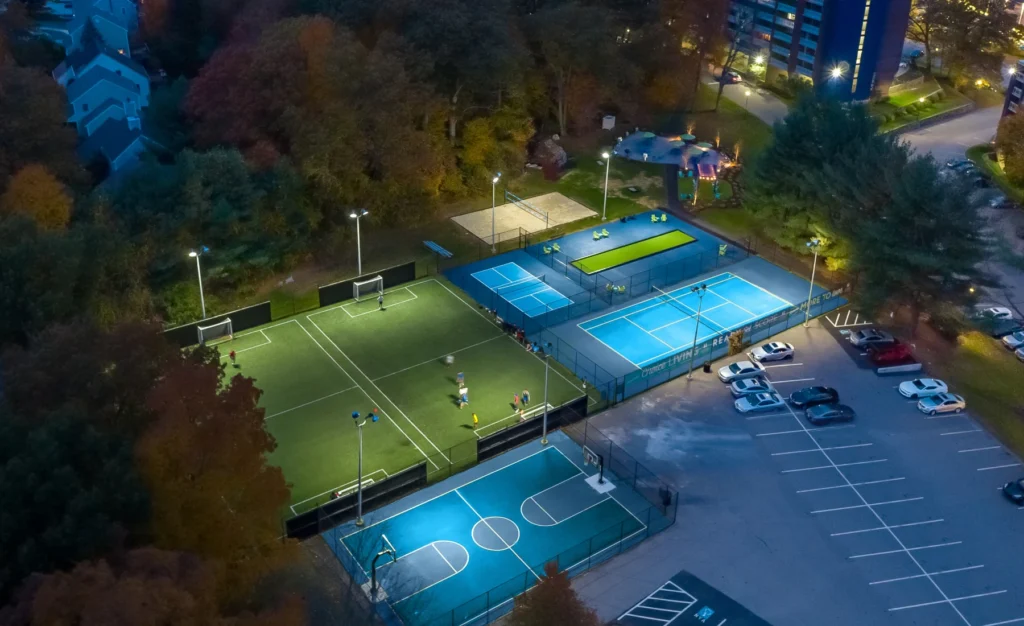 Outdoor sports complex with illuminated soccer, basketball, and tennis courts in Halstead Danvers
