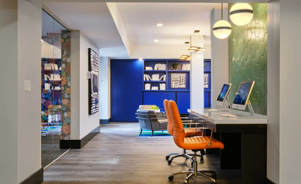 Contemporary tech lounge featuring workstations, statement lighting, and stylish décor touches