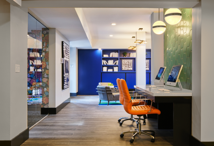 Contemporary tech lounge featuring workstations, statement lighting, and stylish décor touches