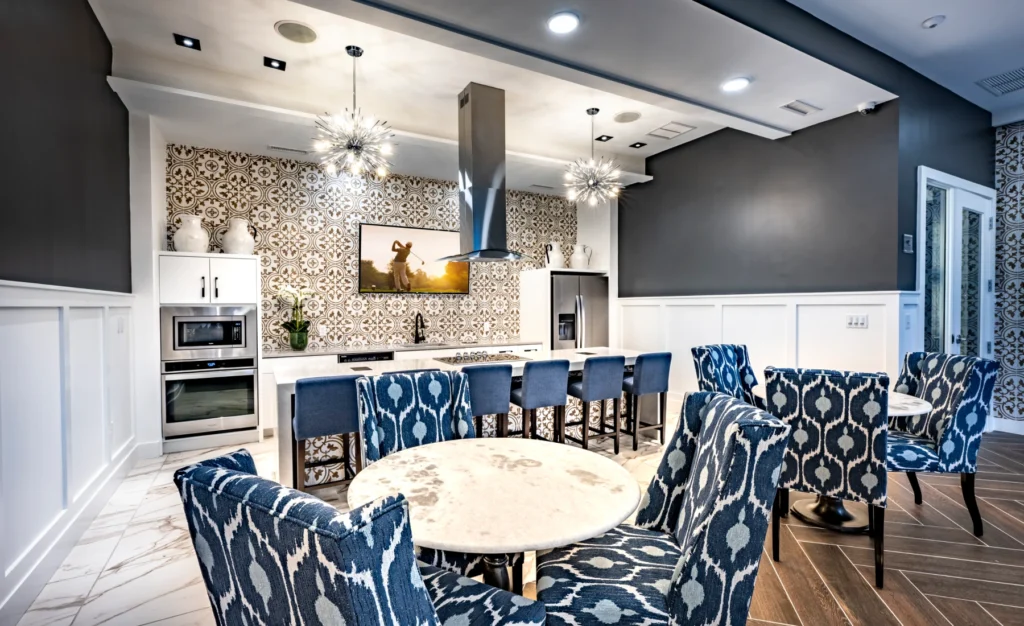 Halstead Maynard stylish community kitchen with patterned wallpaper, marble floors, and modern stainless steel appliances