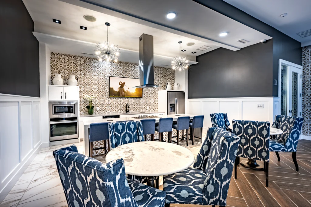 Halstead Maynard stylish community kitchen with patterned wallpaper, marble floors, and modern stainless steel appliances