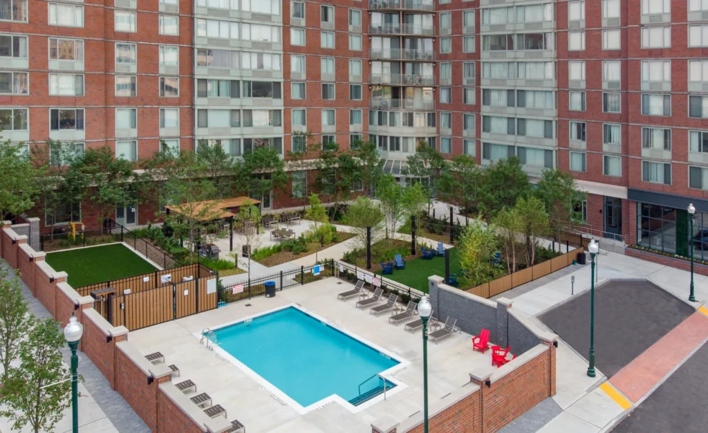 Aerial view of courtyard in Halstead Station with pool, lounge chairs, and green space
